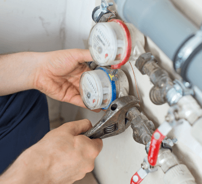 Water_Meter_Installation Person's hands installing a water meter